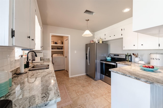 kitchen with appliances with stainless steel finishes, washer / clothes dryer, white cabinetry, and hanging light fixtures