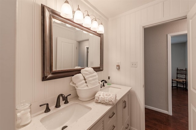 bathroom featuring vanity, wood-type flooring, and crown molding