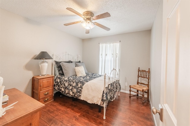 bedroom featuring a textured ceiling, dark hardwood / wood-style flooring, and ceiling fan