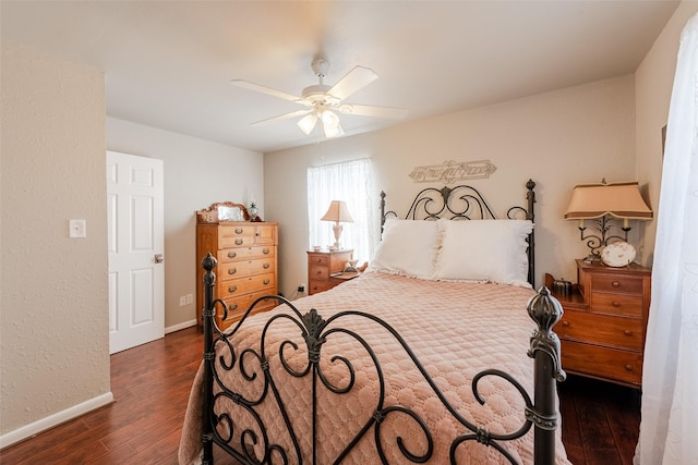 bedroom with ceiling fan and dark wood-type flooring