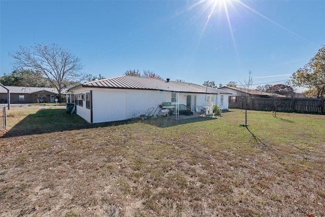 rear view of house with a yard