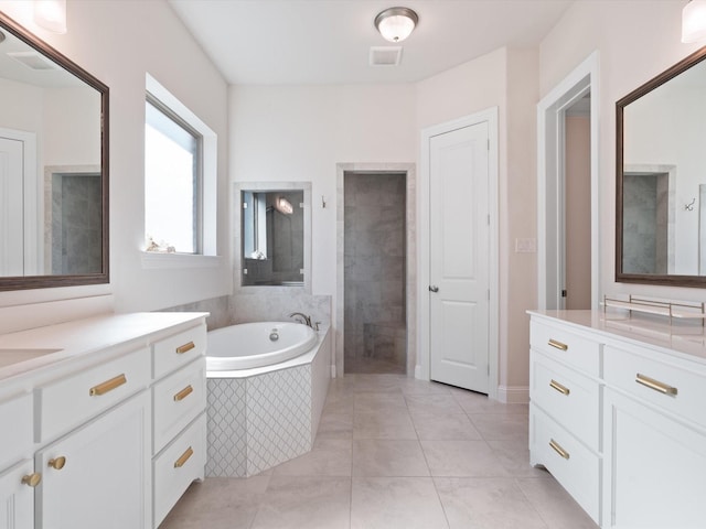 bathroom featuring tile patterned flooring, vanity, and plus walk in shower