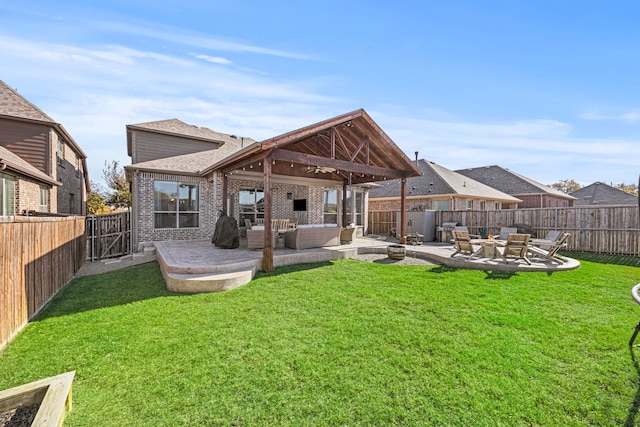 rear view of house featuring a patio area, a fenced backyard, a lawn, and an outdoor hangout area