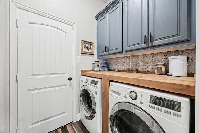 laundry area featuring cabinet space, washing machine and dryer, and dark wood-style flooring