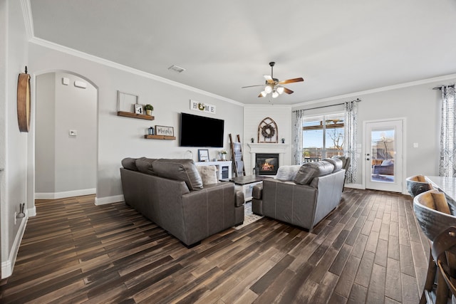 living room with ornamental molding, dark hardwood / wood-style floors, and ceiling fan