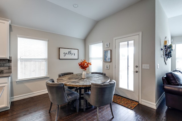 dining space with dark wood-type flooring and lofted ceiling