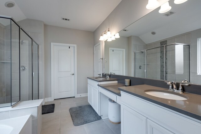 bathroom featuring tile patterned flooring, vanity, walk in shower, and vaulted ceiling