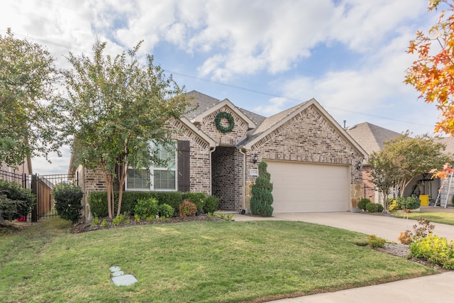 view of front of property with a front yard and a garage