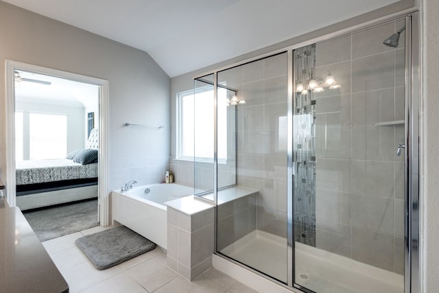 bathroom with tile patterned flooring, vaulted ceiling, and plus walk in shower