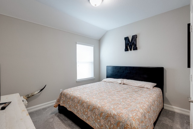 bedroom featuring dark carpet and vaulted ceiling