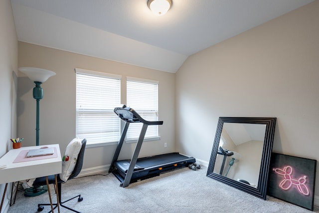 workout room with light carpet and vaulted ceiling