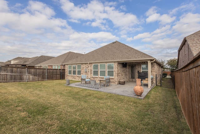 rear view of property featuring a lawn and a patio