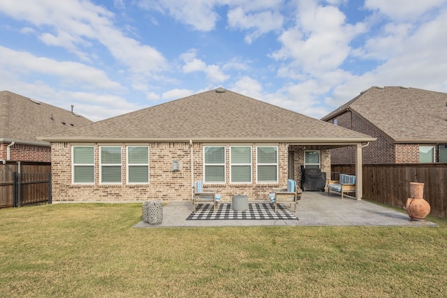 back of property featuring a patio area and a yard