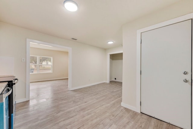 2233 Eastover Ave, Fort Worth, TX 76105 - unfurnished living room featuring light wood-style floors and baseboards