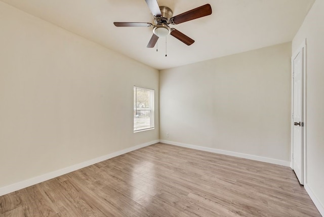 spare room with ceiling fan and light wood-type flooring