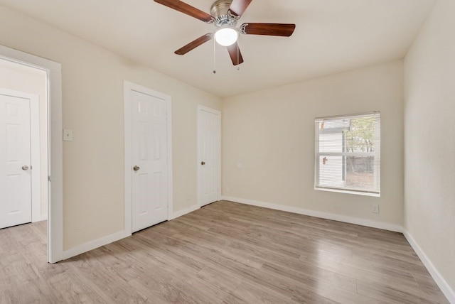 unfurnished bedroom featuring light wood-type flooring and ceiling fan