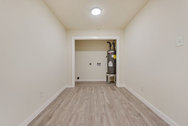 laundry area with hookup for an electric dryer, washer hookup, light hardwood / wood-style floors, and water heater