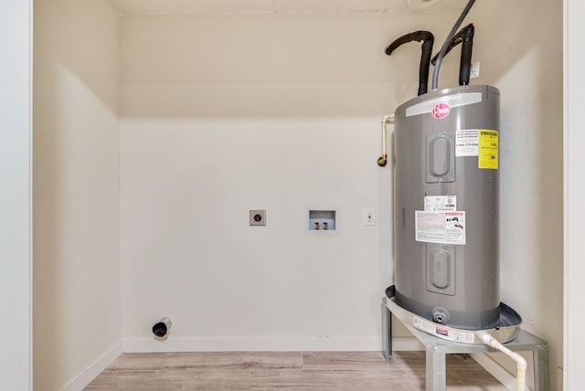 clothes washing area with hookup for an electric dryer, light wood-type flooring, electric water heater, and washer hookup