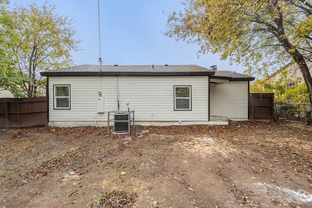 rear view of property with central AC