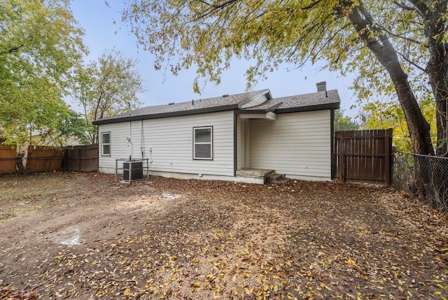 rear view of property featuring central AC