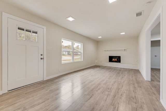 unfurnished living room with light hardwood / wood-style flooring