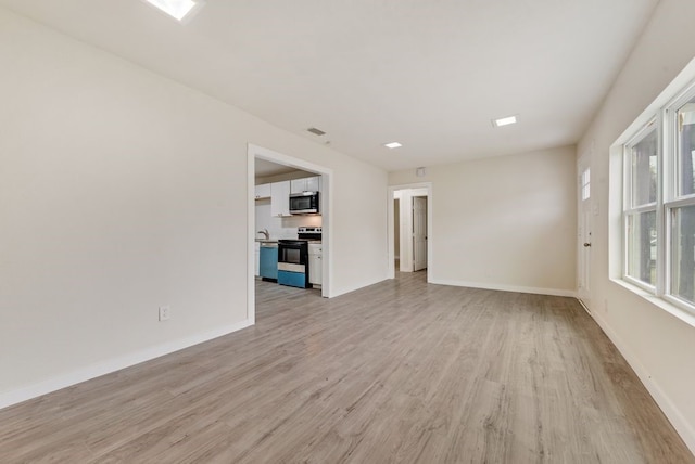 unfurnished living room with light hardwood / wood-style flooring