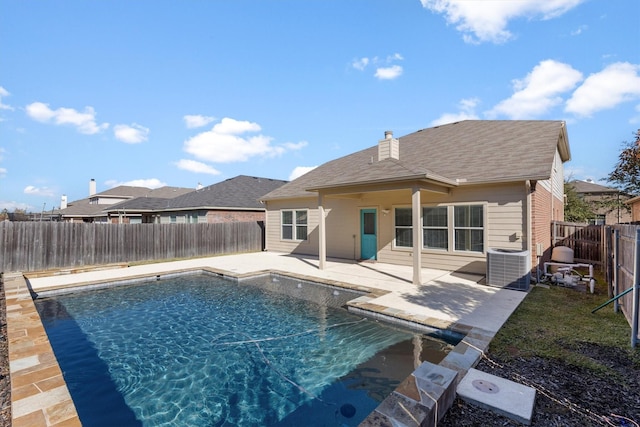 view of pool with cooling unit and a patio