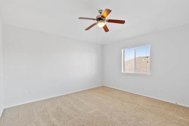 carpeted spare room featuring ceiling fan