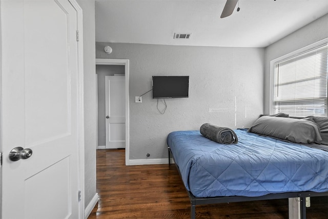 bedroom with ceiling fan and dark hardwood / wood-style flooring