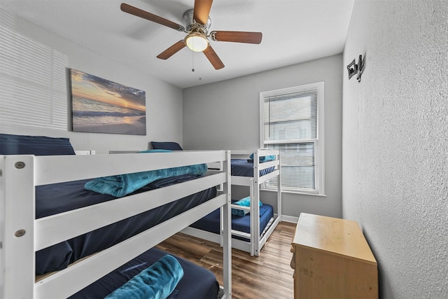 bedroom with ceiling fan and hardwood / wood-style floors