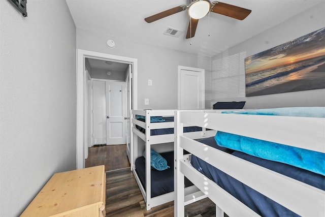 bedroom with ceiling fan and dark wood-type flooring