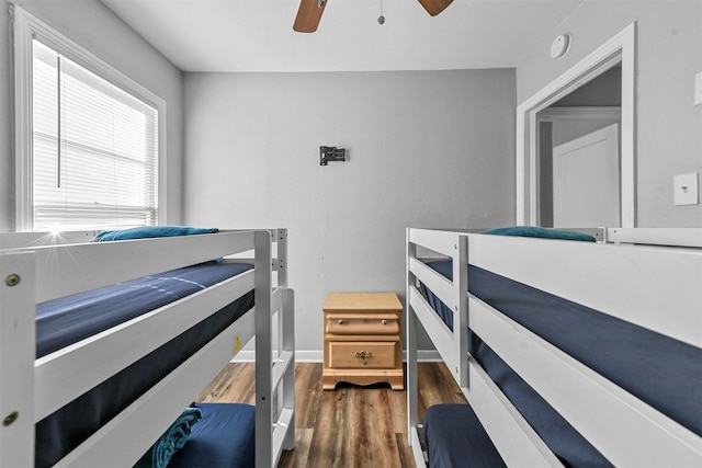 bedroom with ceiling fan and dark wood-type flooring