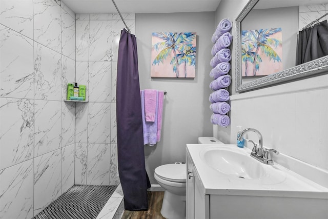 bathroom featuring hardwood / wood-style flooring, toilet, vanity, and walk in shower