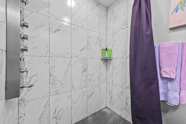 bathroom with a tile shower