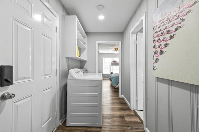 washroom with ceiling fan, washer and clothes dryer, and dark wood-type flooring