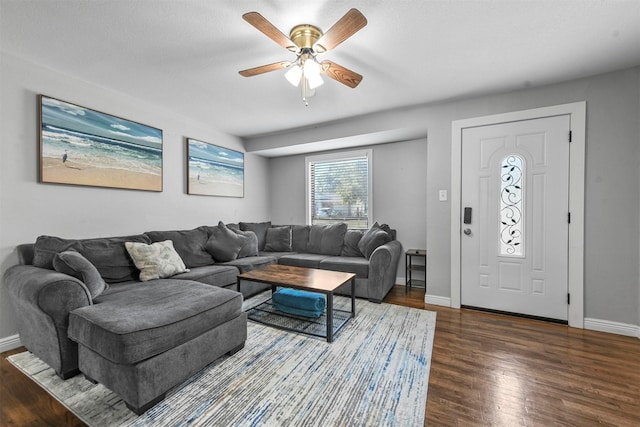 living room featuring ceiling fan, dark hardwood / wood-style flooring, and a textured ceiling