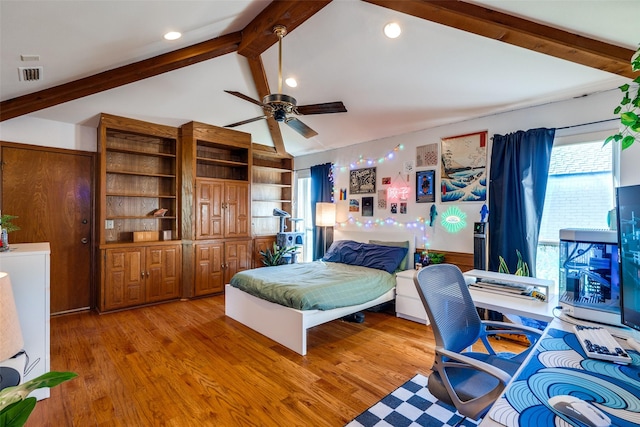 bedroom featuring hardwood / wood-style floors and vaulted ceiling with beams