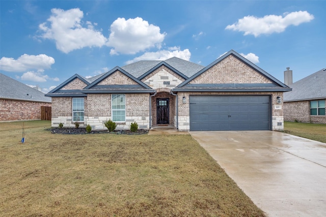 view of front of house with a garage and a front yard