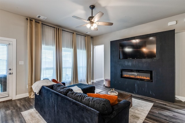 living room featuring a fireplace, ceiling fan, and dark hardwood / wood-style flooring