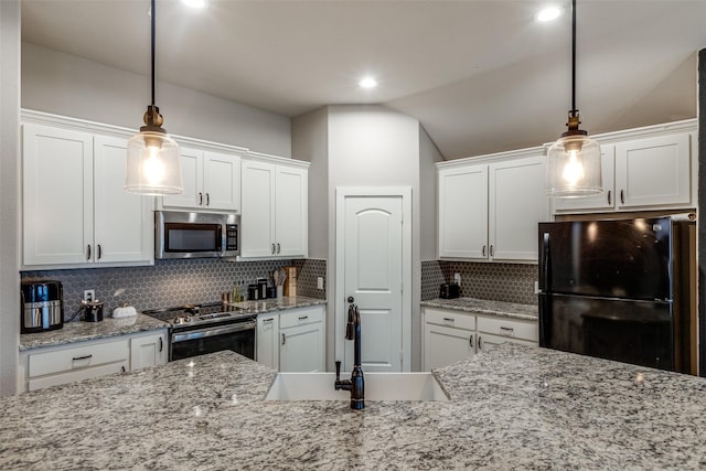 kitchen featuring decorative backsplash, white cabinetry, hanging light fixtures, and stainless steel appliances