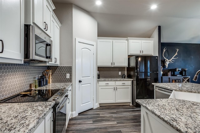 kitchen featuring tasteful backsplash, white cabinetry, stainless steel appliances, and dark hardwood / wood-style floors