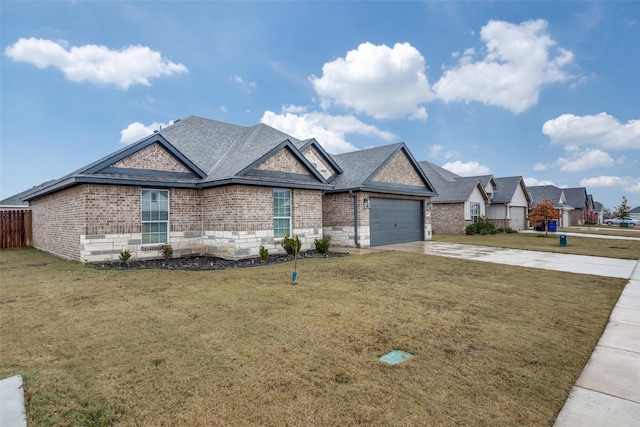 view of front of property featuring a garage and a front lawn