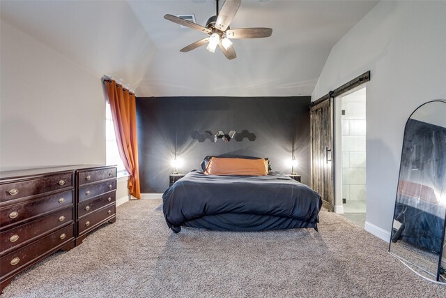 bedroom featuring carpet flooring, ensuite bath, ceiling fan, a barn door, and lofted ceiling