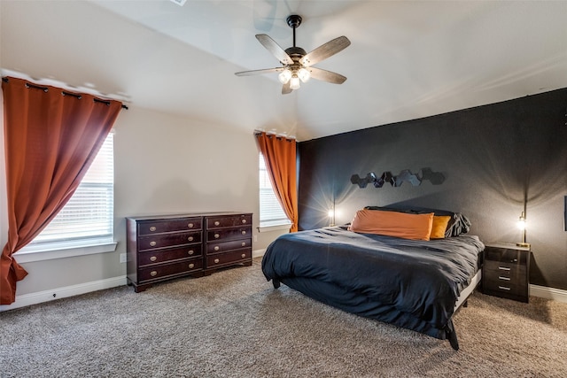 carpeted bedroom featuring multiple windows and ceiling fan