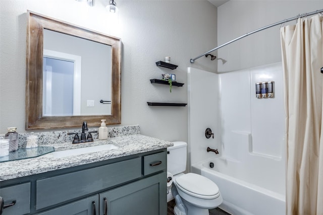 full bathroom featuring shower / bath combo with shower curtain, vanity, and toilet