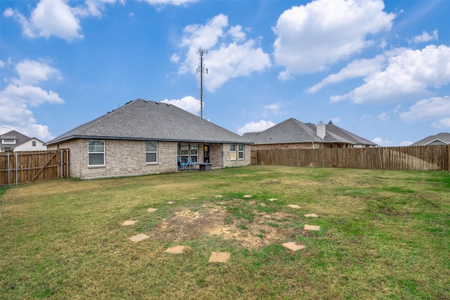 rear view of house with a yard