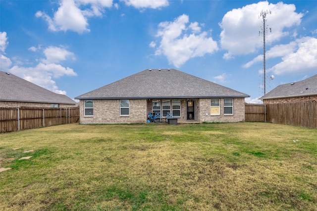 rear view of property featuring a lawn