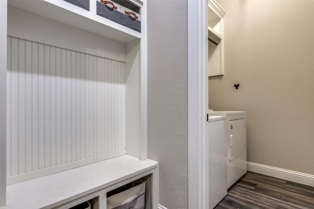 washroom with washing machine and dryer and dark hardwood / wood-style floors