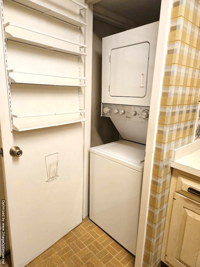 clothes washing area featuring stacked washer and clothes dryer