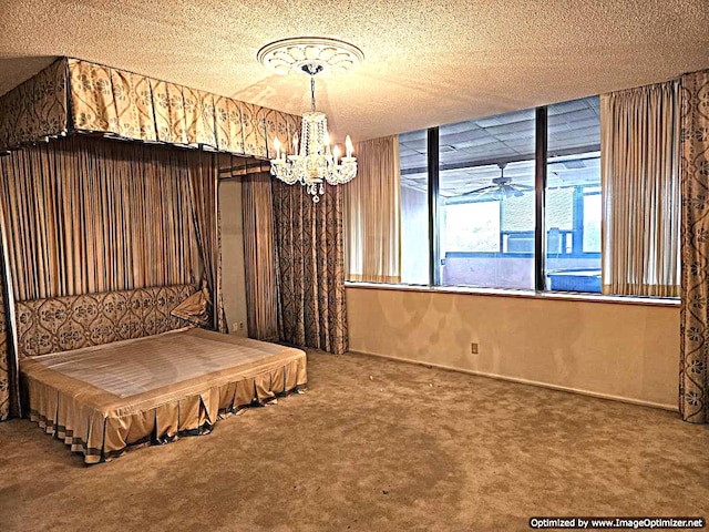 unfurnished bedroom with a chandelier, carpet, and a textured ceiling